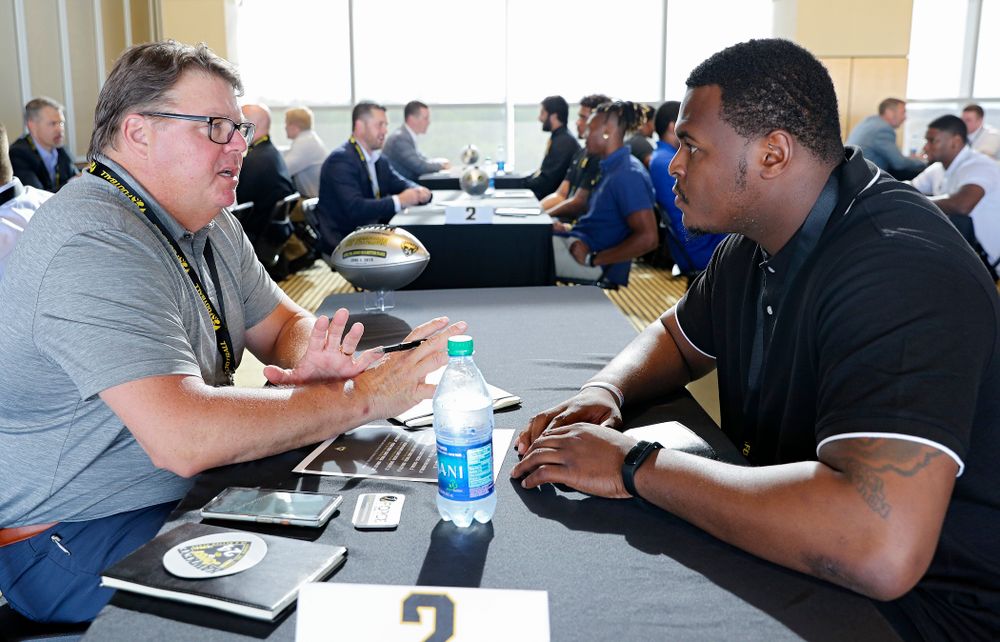 Hap Peterson (from left), former Iowa defensive lineman, talks with defensive lineman Cedrick Lattimore as former players meet with members of the current Hawkeye Football team during a networking event at Kinnick Stadium in Iowa City on Thursday, Jun 6, 2019. (Stephen Mally/hawkeyesports.com)