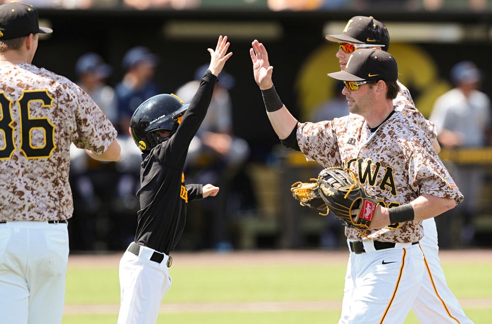 Iowa Hawkeyes left fielder Chris Whelan (28) is greeted as he runs back to the bench after making a diving catch for the final out of the top of third inning of their game against UC Irvine at Duane Banks Field in Iowa City on Sunday, May. 5, 2019. (Stephen Mally/hawkeyesports.com)