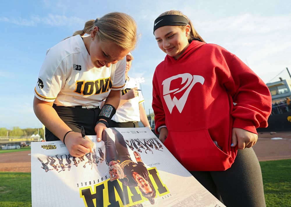 Iowa's Sarah Lehman (16) signs a poster for a fan after winning their game against Ohio State at Pearl Field in Iowa City on Friday, May. 3, 2019. (Stephen Mally/hawkeyesports.com)