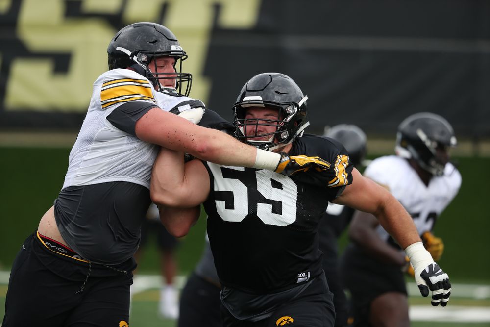 Iowa Hawkeyes offensive lineman Ross Reynolds (59) and defensive end Matt Nelson (96) during practice No. 4 of Fall Camp Monday, August 6, 2018 at the Hansen Football Performance Center. (Brian Ray/hawkeyesports.com)