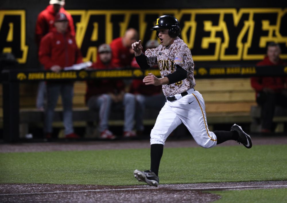 Iowa Hawkeyes outfielder Justin Jenkins (6) scores the game winning run in the bottom of the 9th against the Nebraska Cornhuskers on Military Appreciation Night Friday, April 19, 2019 at Duane Banks Field. (Brian Ray/hawkeyesports.com)