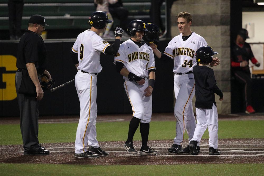 Iowa outfielder Ben Norman (9), Iowa infielder Mitchell Boe (4), Iowa catcher Austin Martin (34) at the game 1 vs Rutgers on Friday, April 5, 2019 at Duane Banks Field. (Lily Smith/hawkeyesports.com)
