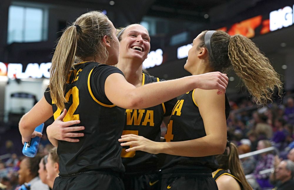 Iowa Hawkeyes guard Kathleen Doyle (22), guard Makenzie Meyer (3), and guard Gabbie Marshall (24) celebrate after guard Megan Meyer (not pictured) made a 3-pointer during the fourth quarter of their game at Welsh-Ryan Arena in Evanston, Ill. on Sunday, January 5, 2020. (Stephen Mally/hawkeyesports.com)