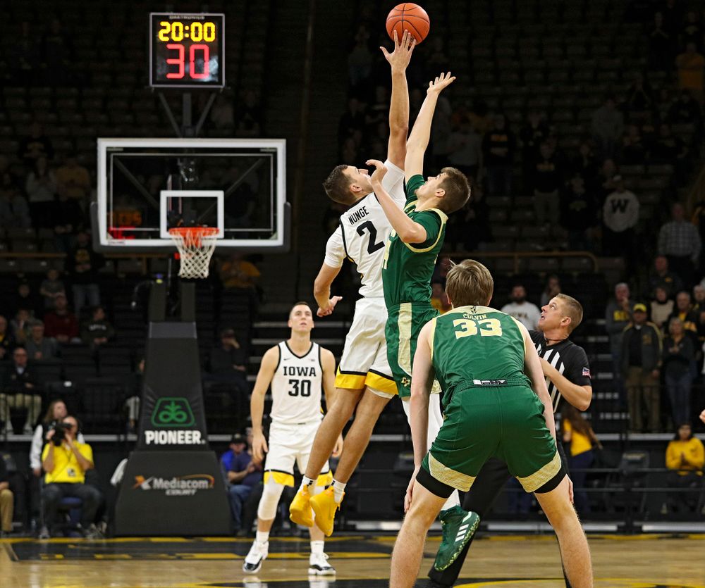 Iowa Hawkeyes forward Jack Nunge (2) gets his hand on the opening tipoff during the first half of their game at Carver-Hawkeye Arena in Iowa City on Sunday, Nov 24, 2019. (Stephen Mally/hawkeyesports.com)