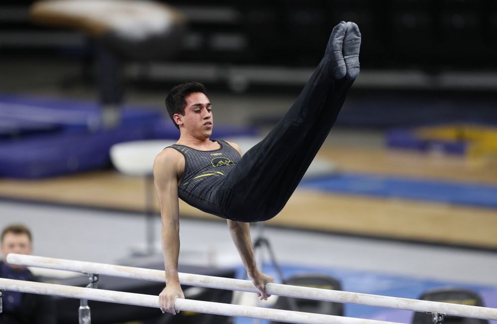 Iowa's Andrew Herrador competes on the parallel bars against Oklahoma Saturday, February 9, 2019 at Carver-Hawkeye Arena. (Brian Ray/hawkeyesports.com)