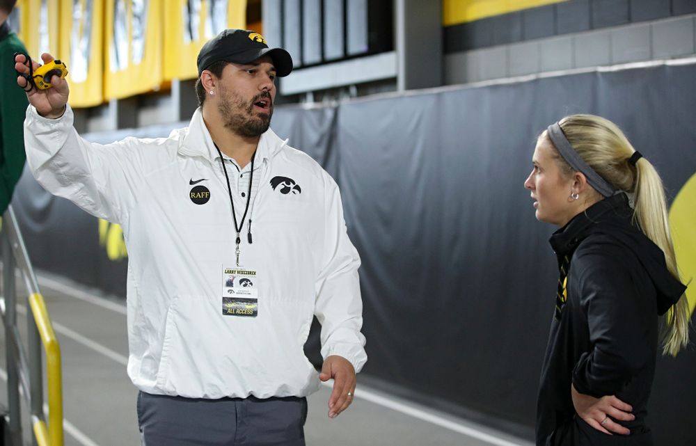 Iowa assistant coach/recruiting coordinator Jason Wakenight (from left) talks with Aly Weum during the Larry Wieczorek Invitational at the Recreation Building in Iowa City on Saturday, January 18, 2020. (Stephen Mally/hawkeyesports.com)