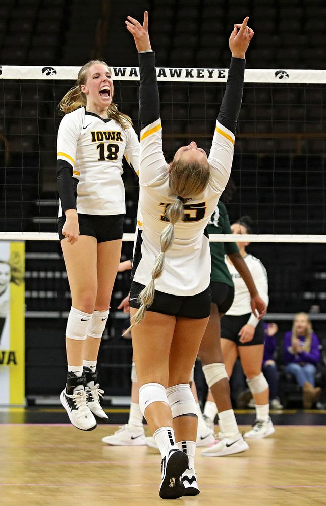 Iowa’s Hannah Clayton (18) and Maddie Slagle (15) celebrate a score during the fourth set of their volleyball match at Carver-Hawkeye Arena in Iowa City on Sunday, Oct 13, 2019. (Stephen Mally/hawkeyesports.com)
