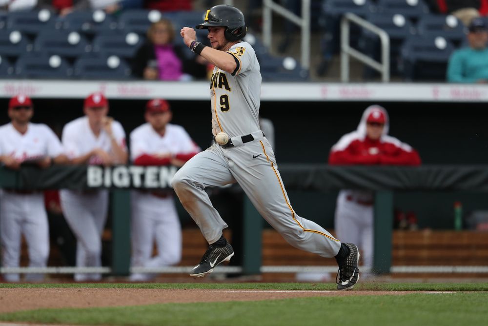 Iowa Hawkeyes outfielder Ben Norman (9) scores against the Indiana Hoosiers in the first round of the Big Ten Baseball Tournament Wednesday, May 22, 2019 at TD Ameritrade Park in Omaha, Neb. (Brian Ray/hawkeyesports.com)