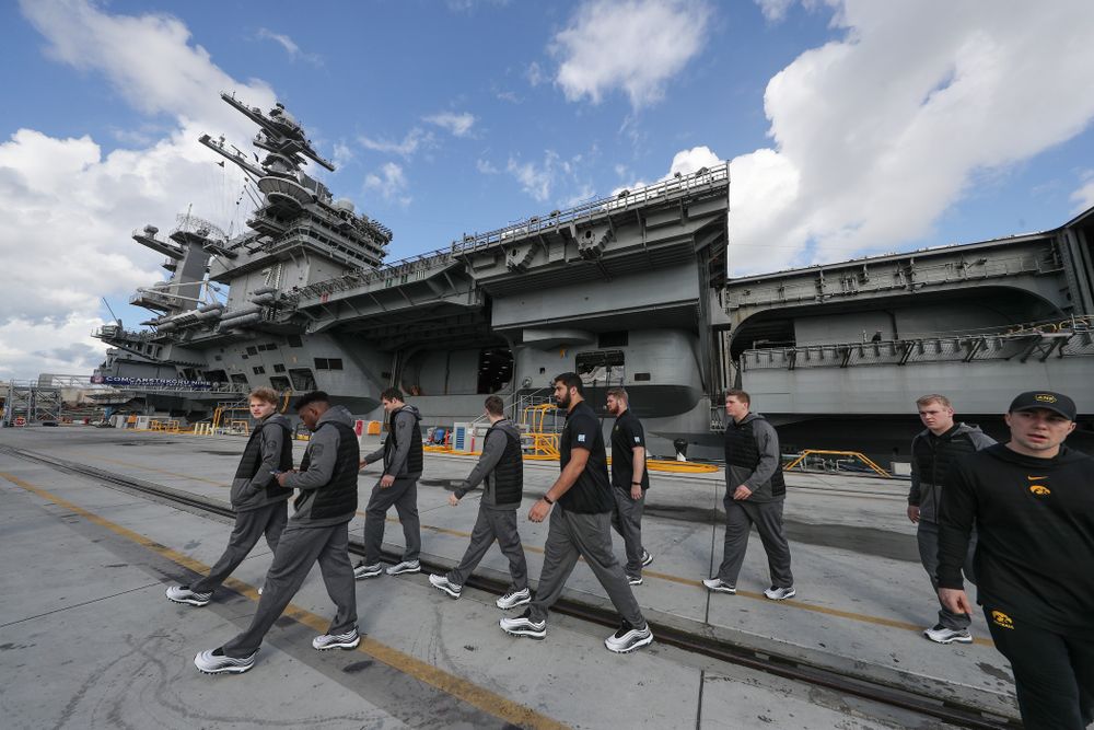 Members of the Iowa Hawkeyes leave the USS Theodore Roosevelt (CVN-71) Tuesday, December 24, 2019 at the Naval Base Coronado (Brian Ray/hawkeyesports.com)
