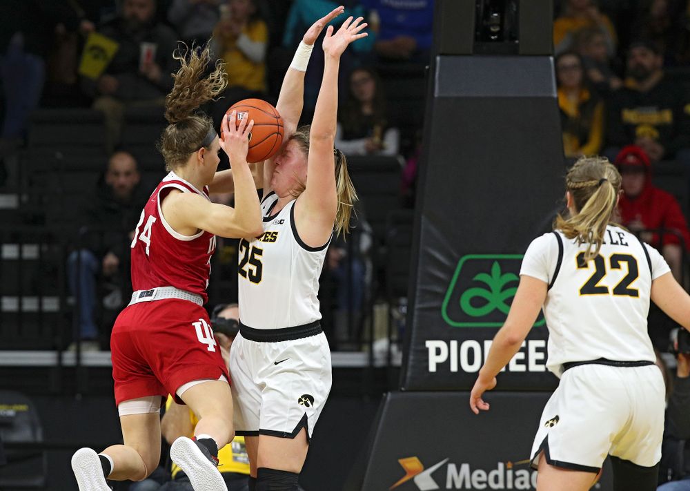 Iowa Hawkeyes forward Monika Czinano (25) holds her ground as Indiana Hoosiers guard Grace Berger (34) looses control of the ball for a turnover during the second quarter of their game at Carver-Hawkeye Arena in Iowa City on Sunday, January 12, 2020. (Stephen Mally/hawkeyesports.com)