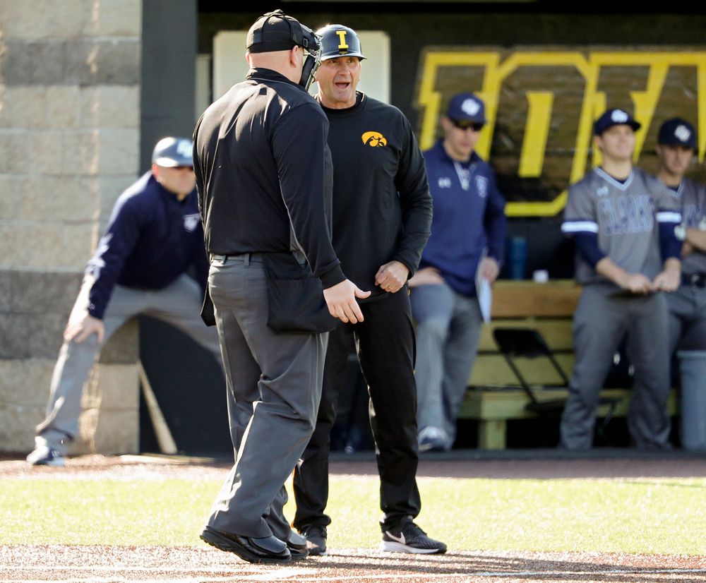 Iowa Hawkeyes head coach Rick Heller talks with the home plate umpire during the first inning of their game at Duane Banks Field in Iowa City on Tuesday, Apr. 2, 2019. (Stephen Mally/hawkeyesports.com)