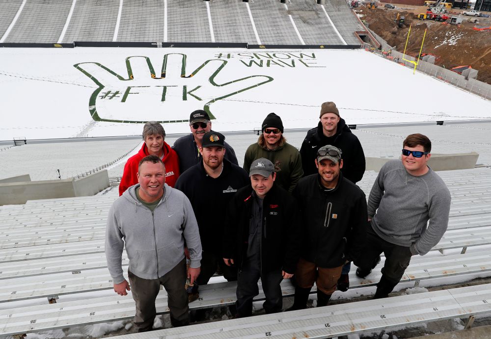 Members of the Iowa Athletics Turf Management staff create the #SnowWave for kids in the Stead Family Children's Hospital Thursday, February