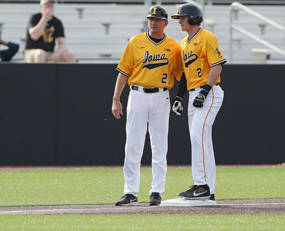 Iowa Hawkeyes head coach Rick Heller (from left) talks with second baseman Brendan Sher (2) on third base during the third inning of their game against Northern Illinois at Duane Banks Field in Iowa City on Tuesday, Apr. 16, 2019. (Stephen Mally/hawkeyesports.com)