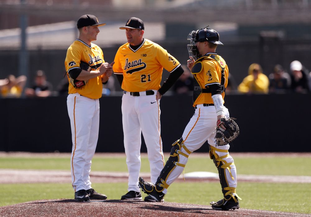 Iowa Hawkeyes pitcher Cole McDonald (11), catcher Tyler Cropley (5), and head coach Rick Heller against the Michigan Wolverines Sunday, April 29, 2018 at Duane Banks Field. (Brian Ray/hawkeyesports.com)