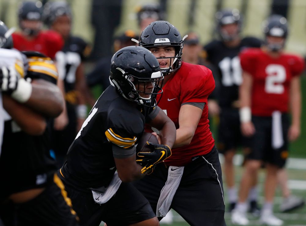quarterback Nathan Stanley (4) and defensive back Josh Turner (4) during camp practice No. 15  Monday, August 20, 2018 at the Hansen Football Performance Center. (Brian Ray/hawkeyesports.com)