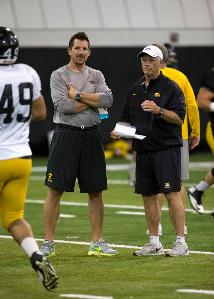 Former Hawkeye  All-American tight end and 11 year NFL veteran Dallas Clark talks with defensive line coach Reese Morgan during the 19th practice of fall camp Wednesday, Aug. 19, 2015 in Iowa City.  (Brian Ray/hawkeyesports.com)
