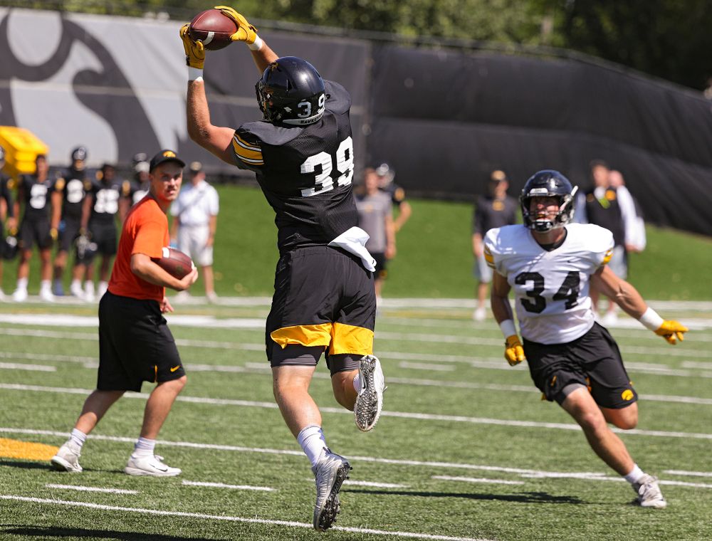 Iowa Hawkeyes tight end Nate Wieting (39) pulls in a pass as linebacker Kristian Welch (34) looks on during Fall Camp Practice No. 7 at the Hansen Football Performance Center in Iowa City on Friday, Aug 9, 2019. (Stephen Mally/hawkeyesports.com)