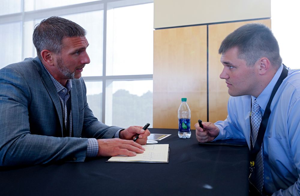Aaron Kampman (from left), former Iowa defensive end, talks with offensive lineman Cole Banwart as former players meet with members of the current Hawkeye Football team during a networking event at Kinnick Stadium in Iowa City on Thursday, Jun 6, 2019. (Stephen Mally/hawkeyesports.com)