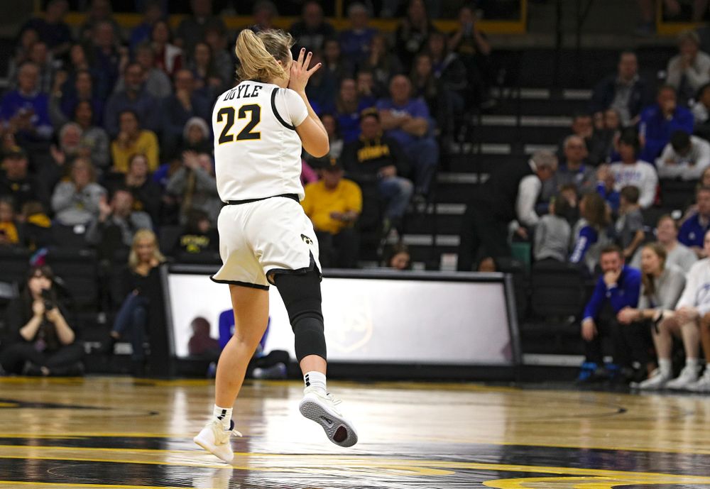 Iowa Hawkeyes guard Kathleen Doyle (22) holds up three-point goggles after making a 3-pointer during the fourth quarter of their game at Carver-Hawkeye Arena in Iowa City on Saturday, December 21, 2019. (Stephen Mally/hawkeyesports.com)