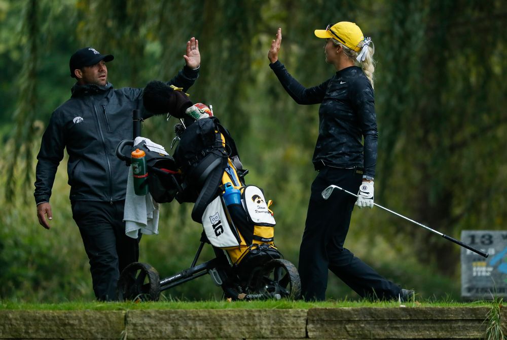 Iowa's Shawn Rennegarbe high-fives assistant coach Michael Roters after hitting a tee shot during the final round of the Diane Thomason Invitational at Finkbine Golf Course on September 30, 2018. (Tork Mason/hawkeyesports.com)