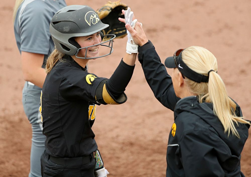 Iowa’s Aralee Bogar (2) gets a high-five from head coach Renee Gillispie during the fourth inning of their game against Iowa Softball vs Indian Hills Community College at Pearl Field in Iowa City on Sunday, Oct 6, 2019. (Stephen Mally/hawkeyesports.com)