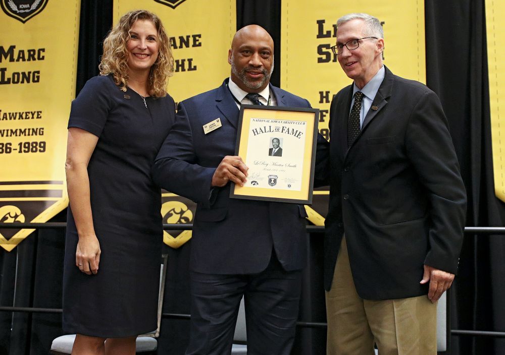Barb Randall (from left), co-chair of the Varsity Club Advisory Committee, 2019 University of Iowa Athletics Hall of Fame inductee LeRoy Smith, and Andy Piro, assistant athletics director and executive director of the Varsity Club, during the Hall of Fame Induction Ceremony at the Coralville Marriott Hotel and Conference Center in Coralville on Friday, Aug 30, 2019. (Stephen Mally/hawkeyesports.com)
