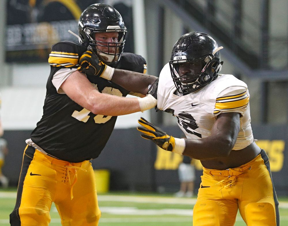 Iowa Hawkeyes offensive lineman Jack Plumb (79) and linebacker Amani Jones (52) work on a drill during Fall Camp Practice No. 6 at the Hansen Football Performance Center in Iowa City on Thursday, Aug 8, 2019. (Stephen Mally/hawkeyesports.com)