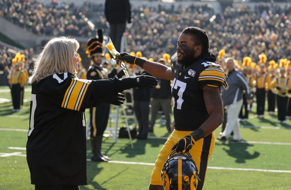 Iowa Hawkeyes defensive back Devonte Young (17) and Kirk and Mary Ferentz during Senior Day festivities before their game against the Illinois Fighting Illini Saturday, November 23, 2019 at Kinnick Stadium. (Brian Ray/hawkeyesports.com)