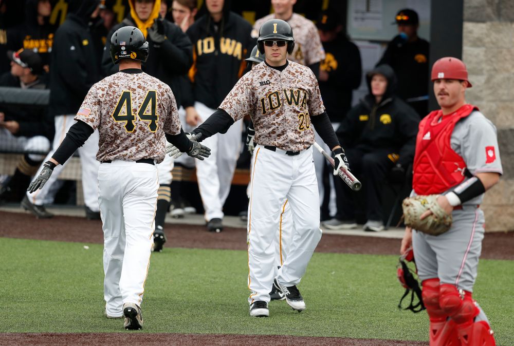Iowa Hawkeyes outfielder Robert Neustrom (44) and catcher Austin Guzzo (20) during a double header against the Indiana Hoosiers Friday, March 23, 2018 at Duane Banks Field. (Brian Ray/hawkeyesports.com)