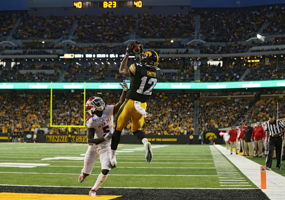 Iowa Hawkeyes wide receiver Brandon Smith (12) pulls in a 9-yard touchdown pass during the second quarter of their game at Kinnick Stadium in Iowa City on Saturday, Aug 31, 2019. (Stephen Mally/hawkeyesports.com)