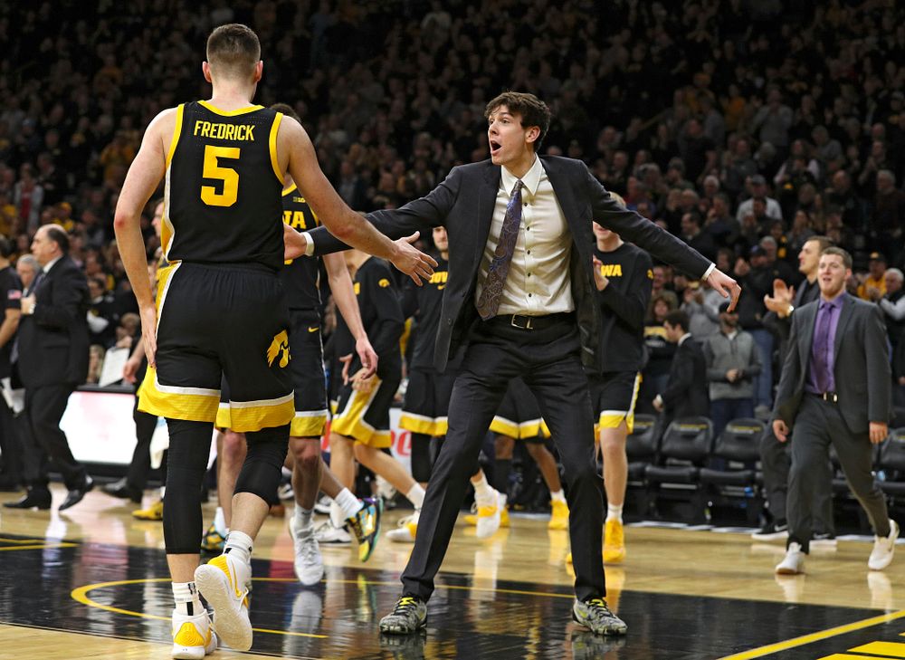 Iowa Hawkeyes forward Patrick McCaffery (right) celebrates with guard CJ Fredrick (5) as he walks back to the bench for a timeout during the second half of their game at Carver-Hawkeye Arena in Iowa City on Monday, January 27, 2020. (Stephen Mally/hawkeyesports.com)