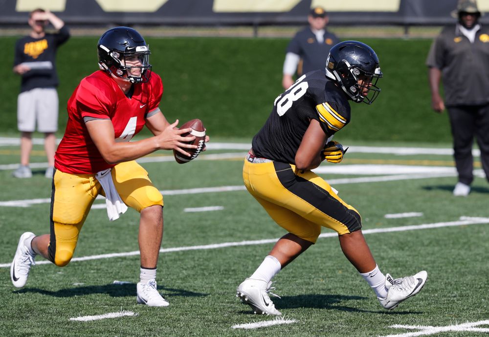 Iowa Hawkeyes quarterback Nathan Stanley (4) and running back Toren Young (28) during camp practice No. 17 Wednesday, August 22, 2018 at the Kenyon Football Practice Facility. (Brian Ray/hawkeyesports.com)