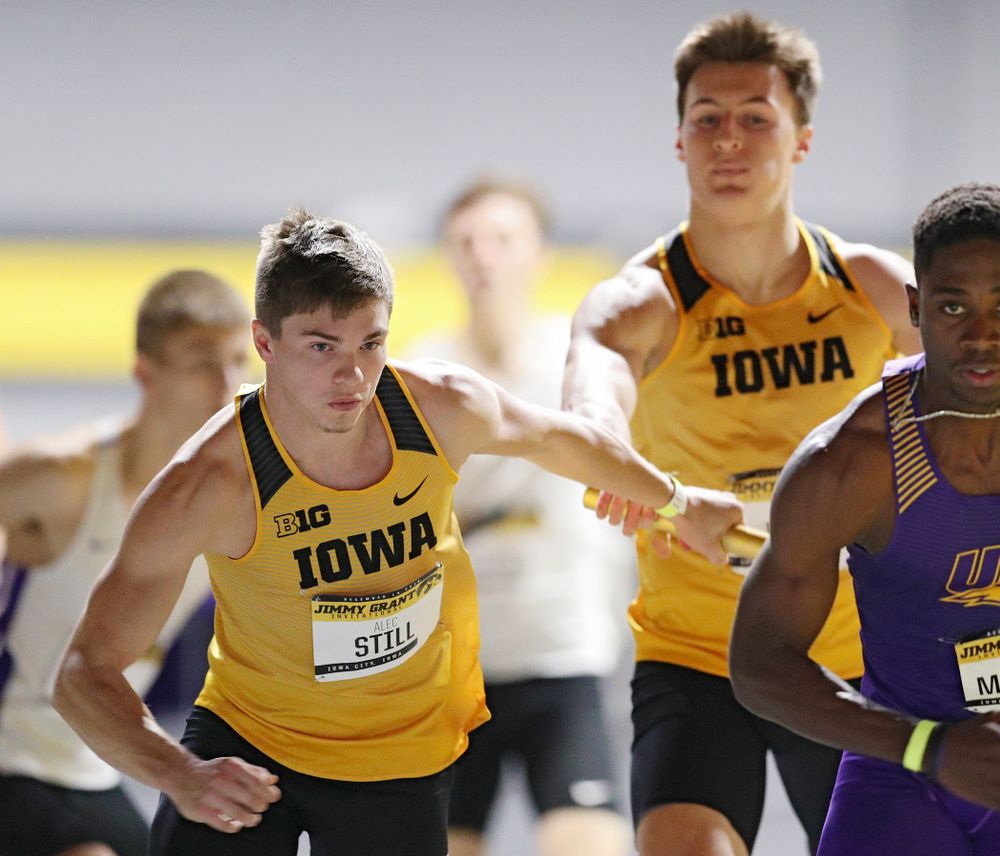Iowa’s Austin West (right) hands the baton to Alec Still as they run the men’s 1600 meter relay event during the Jimmy Grant Invitational at the Recreation Building in Iowa City on Saturday, December 14, 2019. (Stephen Mally/hawkeyesports.com)
