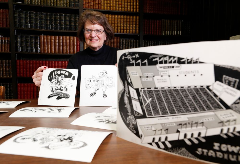 Jane Roth sits with some of the original drawings of Herky the Hawk Friday, April 20, 2018 at the University of Iowa Library. Roth has donated the drawings, which were created by artist Dick Spencer, to the library's special collection. (Brian Ray/hawkeyesports.com)