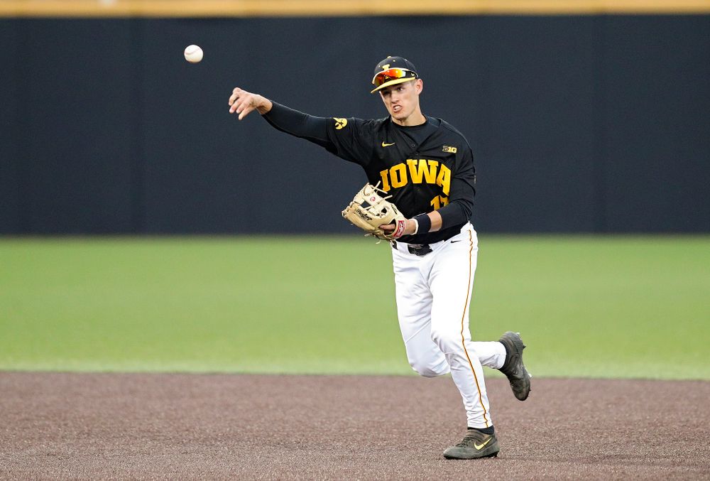 Iowa shortstop Dylan Nedved (17) throws to first for an out during the ninth inning of their college baseball game at Duane Banks Field in Iowa City on Tuesday, March 10, 2020. (Stephen Mally/hawkeyesports.com)