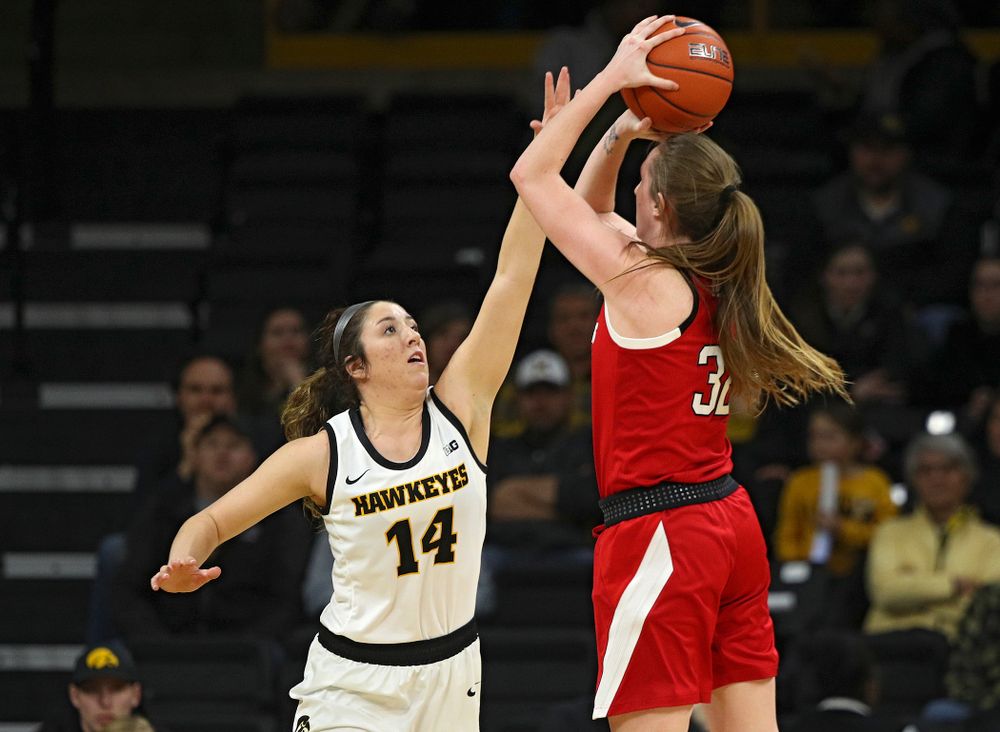 Iowa Hawkeyes guard McKenna Warnock (14) tries to block a shot during the third quarter of the game at Carver-Hawkeye Arena in Iowa City on Thursday, February 6, 2020. (Stephen Mally/hawkeyesports.com)