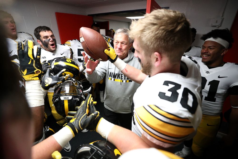 Iowa Hawkeyes defensive back Jake Gervase (30) presents the game ball to head coach Kirk Ferentz to commemorate his 150th win as head coach fo the Iowa Hawkeyes following their 63-0 win over the Illinois Fighting Illini Saturday, November 17, 2018 at Memorial Stadium in Champaign, Ill. (Brian Ray/hawkeyesports.com)
