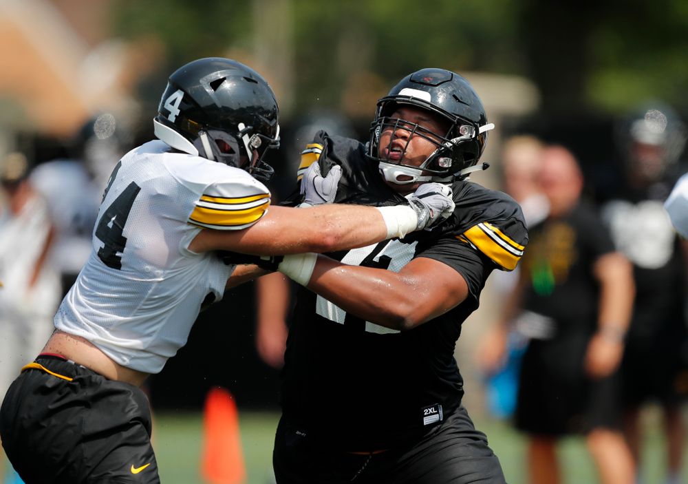 Iowa Hawkeyes offensive lineman Alaric Jackson (77) and linebacker Kristian Welch (34) during fall camp practice No. 9 Friday, August 10, 2018 at the Kenyon Practice Facility. (Brian Ray/hawkeyesports.com)