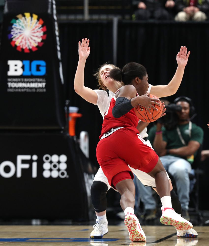 Iowa Hawkeyes guard Kathleen Doyle (22) draws a charging foul against the Indiana Hoosiers in the quarterfinals of the Big Ten Tournament Friday, March 8, 2019 at Bankers Life Fieldhouse in Indianapolis, Ind. (Brian Ray/hawkeyesports.com)