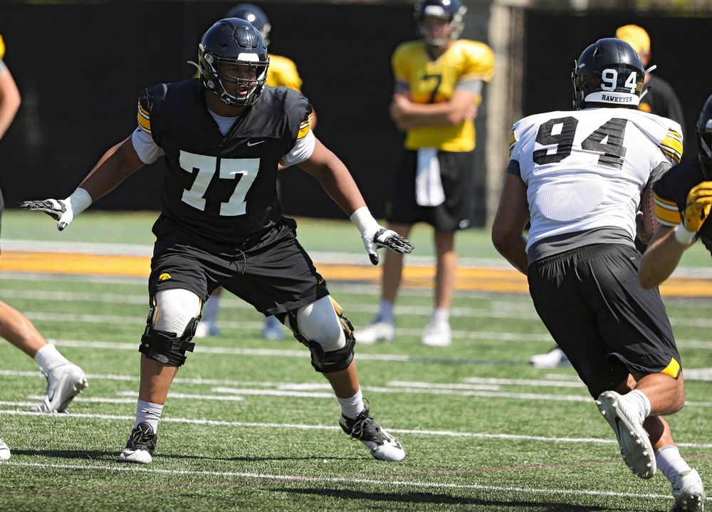Iowa Hawkeyes offensive lineman Alaric Jackson (77) eyes defensive end A.J. Epenesa (94) during Fall Camp Practice No. 7 at the Hansen Football Performance Center in Iowa City on Friday, Aug 9, 2019. (Stephen Mally/hawkeyesports.com)