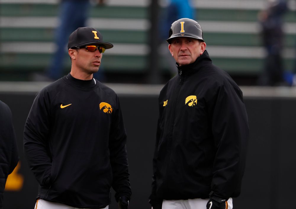 Iowa Hawkeyes pitching coach Desi Druschel and head coach Rick Heller during a double header against the Indiana Hoosiers Friday, March 23, 2018 at Duane Banks Field. (Brian Ray/hawkeyesports.com)