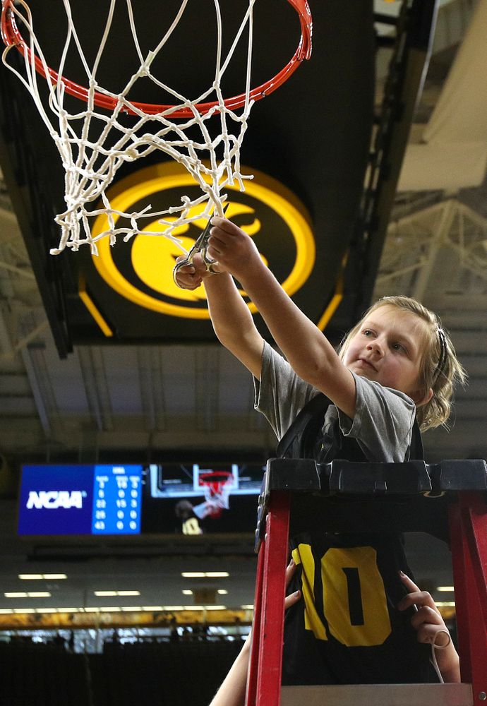 Harper Stribe cuts down the net after the Iowa Hawkeyes won their second round game in the 2019 NCAA Women's Basketball Tournament at Carver Hawkeye Arena in Iowa City on Sunday, Mar. 24, 2019. (Stephen Mally for hawkeyesports.com)