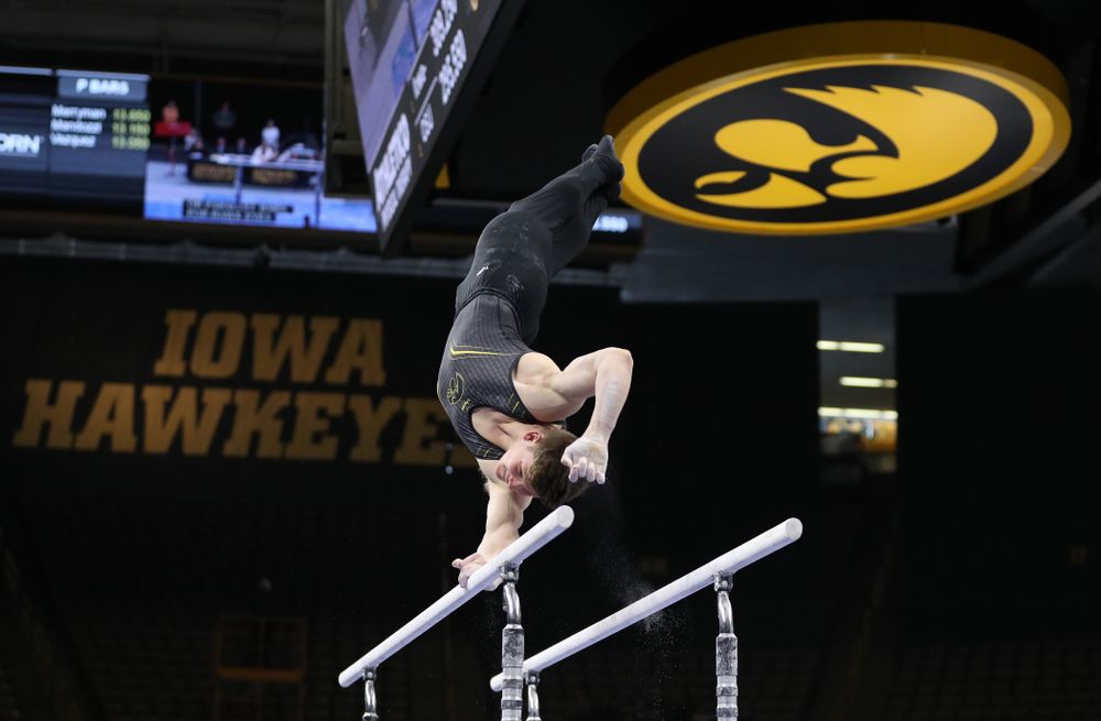 Iowa's Stewart Brown competes on the parallel bars against the Ohio State Buckeyes  Saturday, March 16, 2019 at Carver-Hawkeye Arena.  (Brian Ray/hawkeyesports.com)