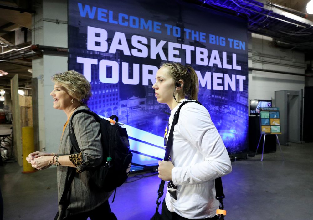 Iowa Hawkeyes head coach Lisa Bluder and guard Kathleen Doyle (22) arrive for their game against Ohio State in the quarterfinals of the Big Ten Basketball Tournament Friday, March 6, 2020 at Bankers Life Fieldhouse in Indianapolis. (Brian Ray/hawkeyesports.com)