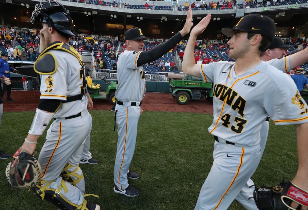 Iowa Hawkeyes head coach Rick Heller and Grant Leonard (43) against the Indiana Hoosiers in the first round of the Big Ten Baseball Tournament Wednesday, May 22, 2019 at TD Ameritrade Park in Omaha, Neb. (Brian Ray/hawkeyesports.com)