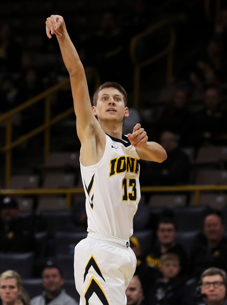 Iowa Hawkeyes guard Austin Ash (13) shoots a 3-pointer during a game against Guilford College at Carver-Hawkeye Arena on November 4, 2018. (Tork Mason/hawkeyesports.com)
