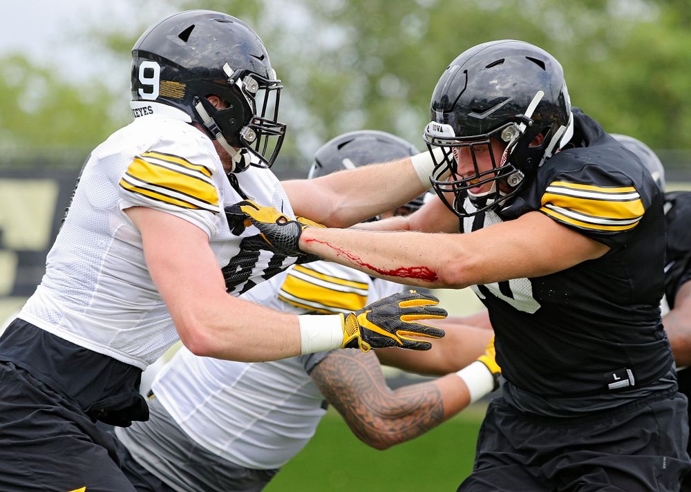 Iowa Hawkeyes linebacker Nick Niemann (49) tries to get around tight end Drew Cook (18) during Fall Camp Practice No. 15 at the Hansen Football Performance Center in Iowa City on Monday, Aug 19, 2019. (Stephen Mally/hawkeyesports.com)