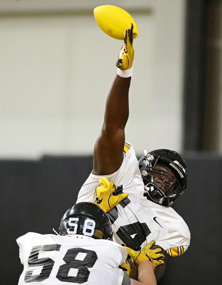 Iowa Hawkeyes defensive tackle Daviyon Nixon (54) knocks down a pass as he is blocked by offensive lineman Taylor Fox (58) during Fall Camp Practice No. 9 at the Hansen Football Performance Center in Iowa City on Monday, Aug 12, 2019. (Stephen Mally/hawkeyesports.com)