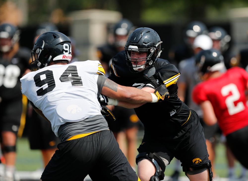 Iowa Hawkeyes offensive lineman Mark Kallenberger (71) and defensive end A.J. Epenesa (94) during fall camp practice No. 9 Friday, August 10, 2018 at the Kenyon Practice Facility. (Brian Ray/hawkeyesports.com)
