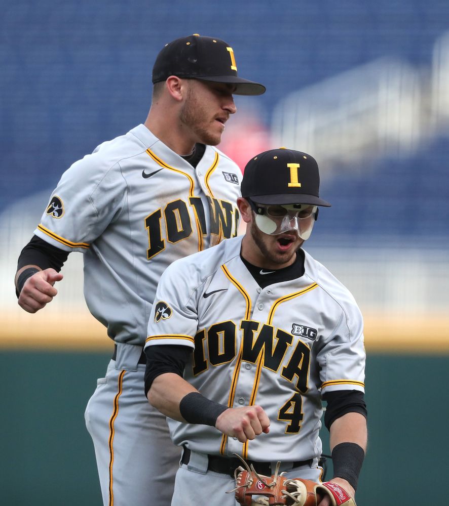 Iowa Hawkeyes Tanner Wetrich (16) and infielder Mitchell Boe (4) celebrate after tuning a double play against the Indiana Hoosiers in the first round of the Big Ten Baseball Tournament Wednesday, May 22, 2019 at TD Ameritrade Park in Omaha, Neb. (Brian Ray/hawkeyesports.com)